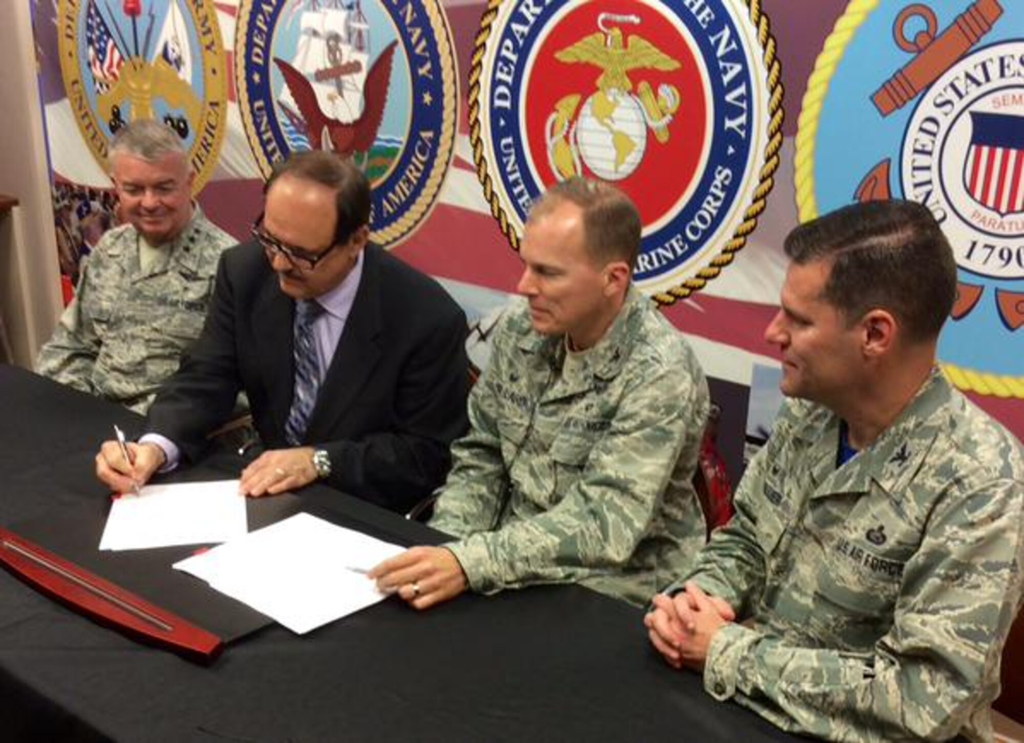 Air Force Surgeon General Lt. Gen. Thomas Travis, left, joins Jack Hetrick, Network Director for Veterans Integrated Service Network, VISN 10; Col. Tim Ballard, 88th Medical Group commander; and Col. John Devillier, Wright-Patterson AFB Installation Commander, during a signing ceremony May 1 at WPAFB, which establishes the Buckeye Federal Healthcare Consortium.  The landmark agreement will optimize the use of DoD and VA medical resources in Ohio, Indiana and Kentucky by allowing the VA to send eligible veterans to the Wright-Patterson Medical Center for inpatient our outpatient services, expanding the current relationship between VISN 10 and DoD.  According to Colonel Ballard the agreement also will, “keep our staff prepared to accomplish their wartime mission, while offering quality medical service to our veterans.” For full coverage: http://bit.ly/1I8no4D.  (U.S. Air Force photo by Wesley Farnsworth / Released)
