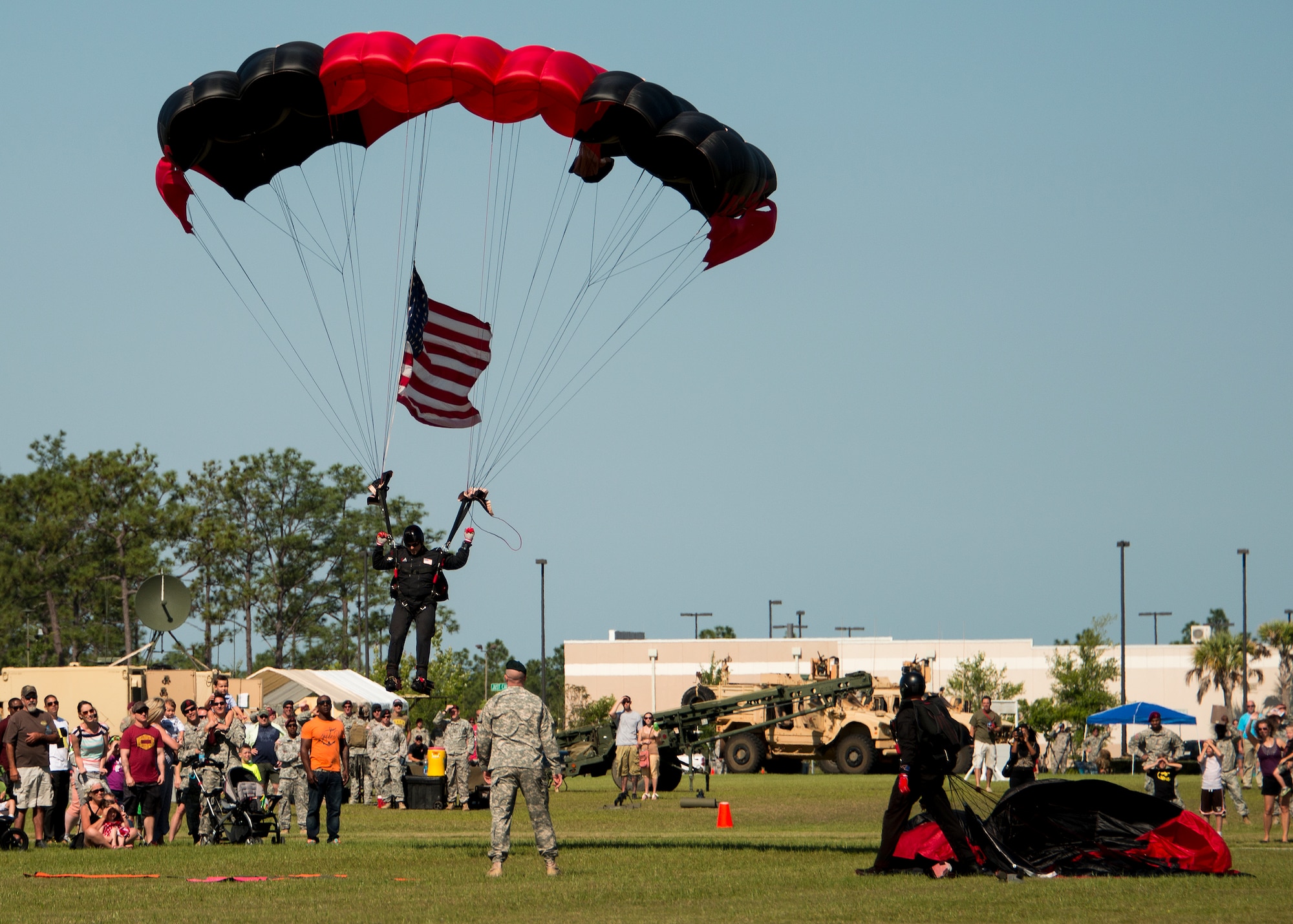 Members of the U. S. Army Special Operations Command’s Black Daggers Parachute Demonstration Team drop onto Eglin Air Force Base during the 7th Special Forces Group (Airborne) Red Empire Week Community Day May 5.  A Duke Field C-145 flew to serve as the team’s free-fall jump platform.  (U.S. Air Force photo/Tech. Sgt. Jasmin Taylor)

