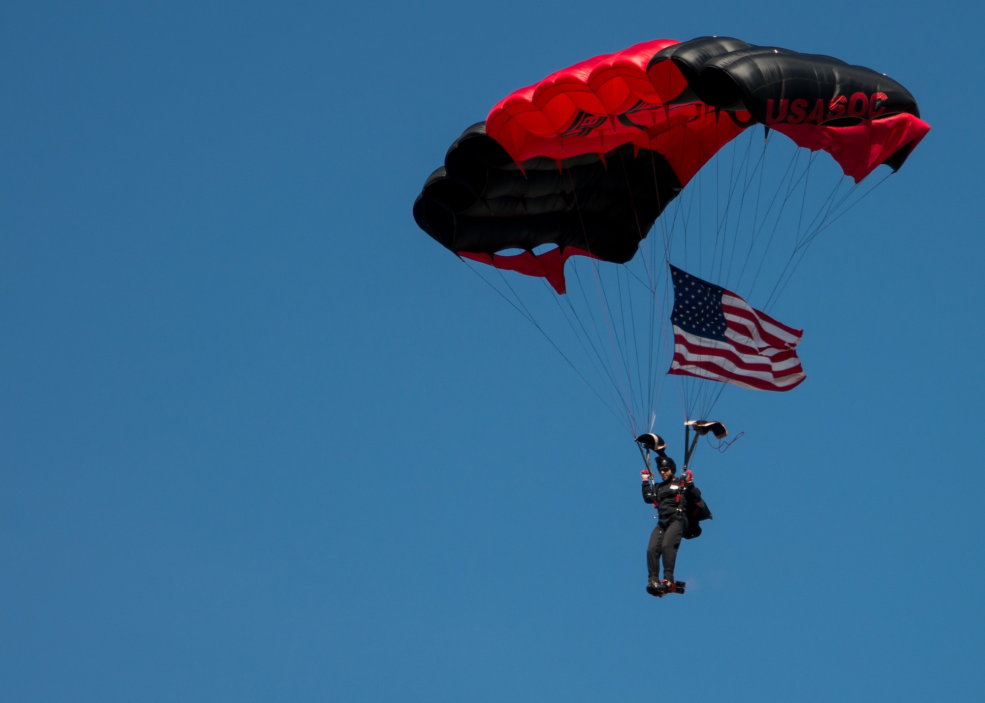 A member of the U. S. Army Special Operations Command’s Black Daggers Parachute Demonstration Team parachutes onto Eglin Air Force Base during the 7th Special Forces Group (Airborne) Red Empire Week Community Day May 5.  A Duke Field C-145 flew to serve as the team’s free-fall jump platform.  (U.S. Air Force photo/Tech. Sgt. Jasmin Taylor)
