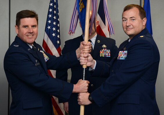 U.S. Air Force Col. Matthew Anderer, left, 721st Air Mobility Operations Group commander, Ramstein Air Base, Germany, passes the 727th Air Mobility Squadron guidon to U.S. Air Force Maj. Sean Lewis, incoming 727th AMS commander, during the 727th AMS change of command ceremony May 6, 2015, on RAF Mildenhall, England. Lewis was previously an Air Mobility Command Phoenix Mobility Officer and the deputy chief of plans and programs for the 621st Contingency Response Wing, Travis Air Base, Calif. (U.S. Air Force photo by Gina Randall/Released)