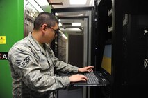 Senior Airman William Seagle programs the Avaya 5300 Voice-Over-Internet-Protocol telephone switch on Joint Base Andrews, Md., April 30, 2015. Seagle is a 744th Communications Squadron Telephone Shop cyber transport technician. (U.S. Air Force photo/Master Sgt. Tammie Moore)