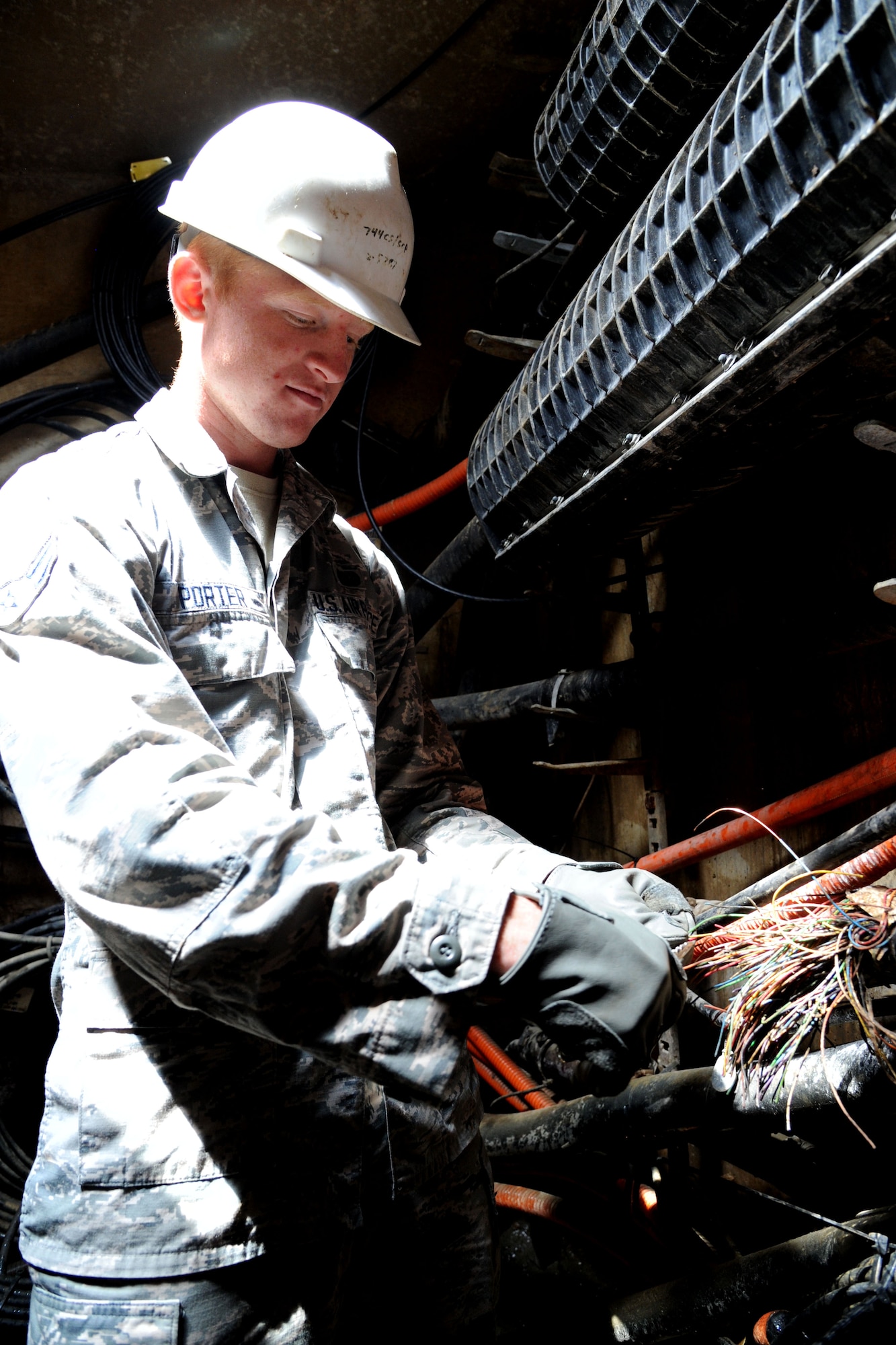 Airman 1st Class Cameron Porter performs a preventive maintenance inspection at Joint Base Andrews, Md., April 30, 2015. Airmen from the 744th Communications Squadron Cable Maintenance Shop are responsible for managing and maintaining underground communication cables. Porter is a 744th CS cable maintenance technician. (U.S. Air Force photo/Master Sgt. Tammie Moore)