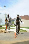 Senior Airmen Cortland Carpenter (left) and Christopher Anderson use GPS to mark cable infrastructure near the Air National Guard Headquarters on Joint Base Andrews, Md., April 30, 2015. Both Airmen are 744th Communications Squadron cable maintenance technicians. (U.S. Air Force photo/Master Sgt. Tammie Moore) 