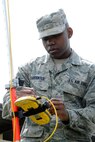 Senior Airman Cortland Carpenter uses GPS to mark cable infrastructure near the Air National Guard Headquarters on Joint Base Andrews, Md., April 30, 2015. Carpenter is a 744th Communications Squadron cable maintenance technician. (U.S. Air Force photo/Master Sgt. Tammie Moore)