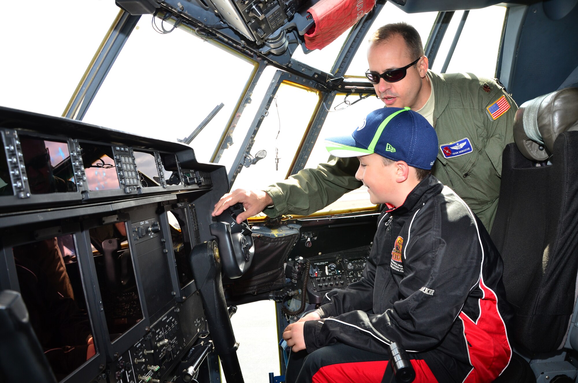 Maj. Ivan DeRoche, a pilot with the 53rd Weather Reconnaissance Squadron Hurricane Hunters, explains the flight controls to a young visitor during the Halifax, Nova Scotia stop of the 2015 Hurricane Awareness Tour May 3. (U.S. Air Force photo/Master Sgt. Brian Lamar)