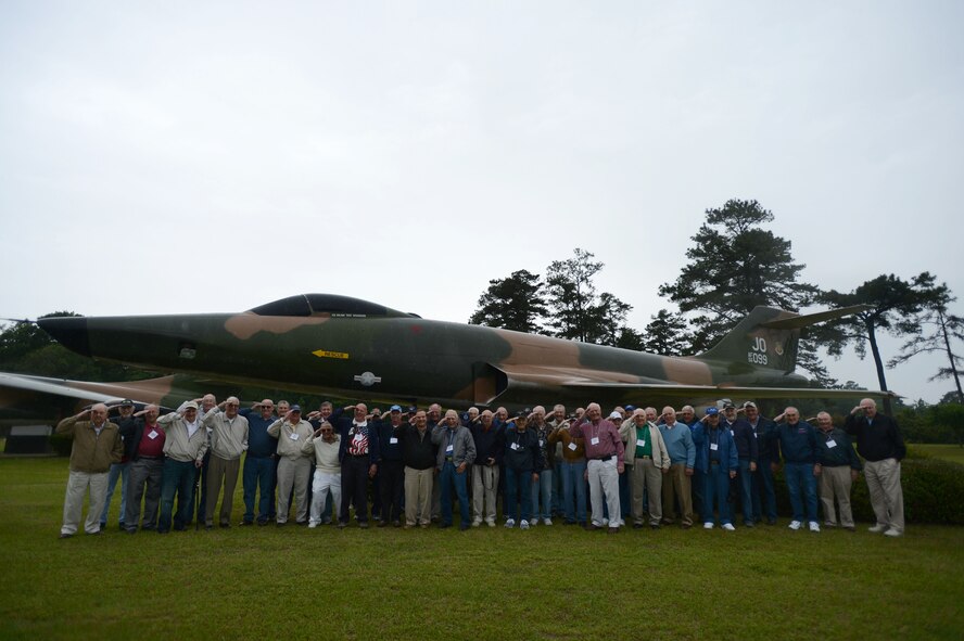 RF-101 Voodoo pilots render salutes in front of a static Voodoo, during their last large reunion at Shaw Air Force Base, S.C., April 29, 2015. While visiting the base the pilots received a tour and watched the F-16 Viper Demo Team to see it’s war-fighting capabilities. (U.S. Air Force photo by Senior Airman Jensen Stidham/Released)