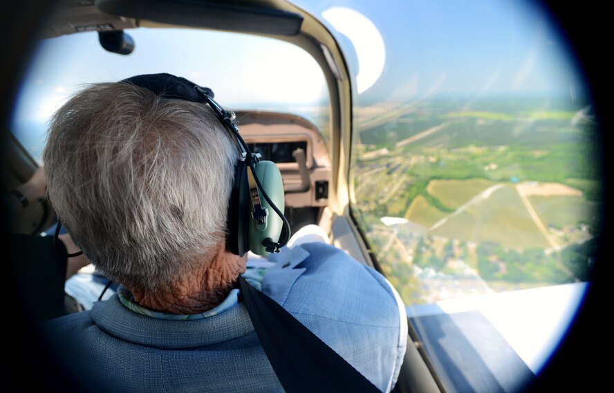 U.S. Air Force retired Maj. Gen. George Edwards Jr, receives a flight in a private aircraft over Shaw Air Force Base, S.C., April 30, 2015. During the finale RF-101 Voodoo reunion, the war-fought pilots toured the base as well as viewed the F-16 Viper Demo Team. (U.S. Air Force photo by Senior Airman Jensen Stidham/Released)