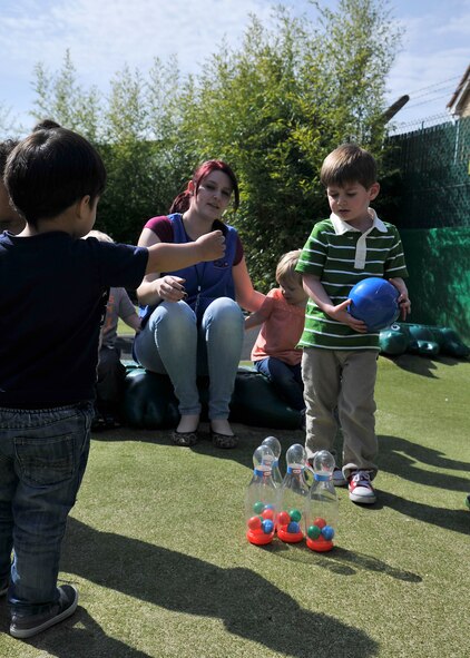 Raven Spangler, center, RAF Mildenhall Child Development Center staff member from Fort Walton Beach, Fla., supervises toddlers while playing outside April 15, 2015, at the CDC on RAF Mildenhall, England. The CDC staff work as a dedicated team to provide a caring and educational environment for children. (U.S. Air Force photo by Airman 1st Class Kyla Gifford/Released)