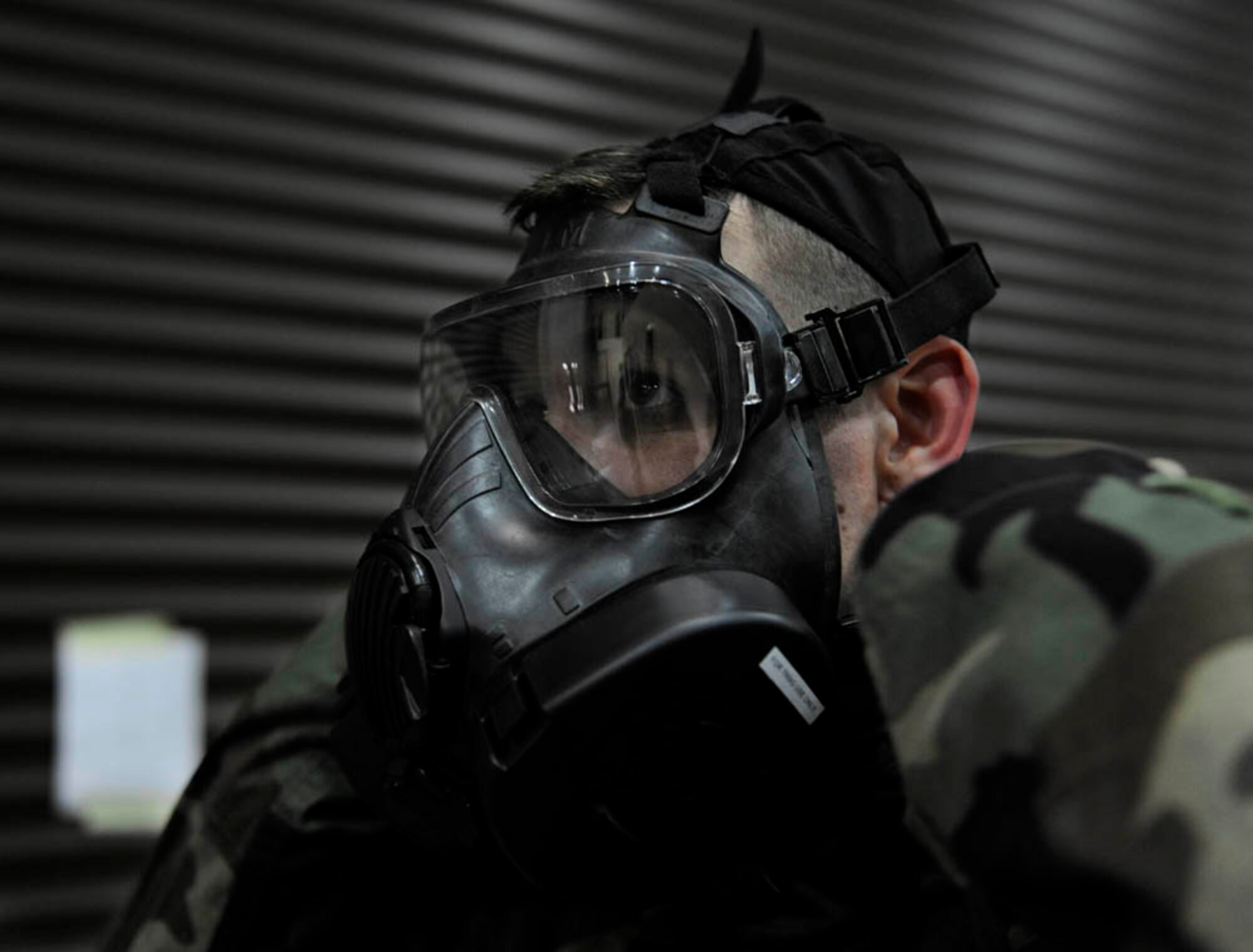 Staff Sgt. Shea Townsend, 39th Comptroller Squadron cashier, dons a gas mask during a base wide exercise April 29, 2015, at Incirlik Air Base, Turkey. As part of the exercise, Airmen from across Incirlik gathered to participate in chemical, biological, radiological and nuclear warfare refresher training. (U.S. Air Force photo by Senior Airman Krystal Ardrey/Released)