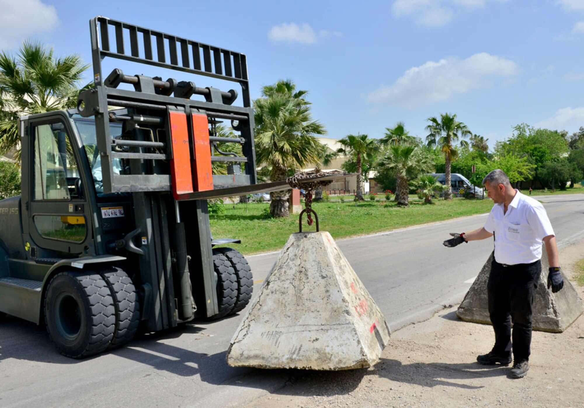 Members from the 39th Logistics Readiness Squadron install road barriers during a base-wide exercise April 30, 2015, at Incirlik Air Base, Turkey. Barriers were placed at key facilities throughout the base to test response times of the 39th LRS in case of a real world situation. (U.S. Air Force photo by Senior Airman Michael Battles/Released) 
