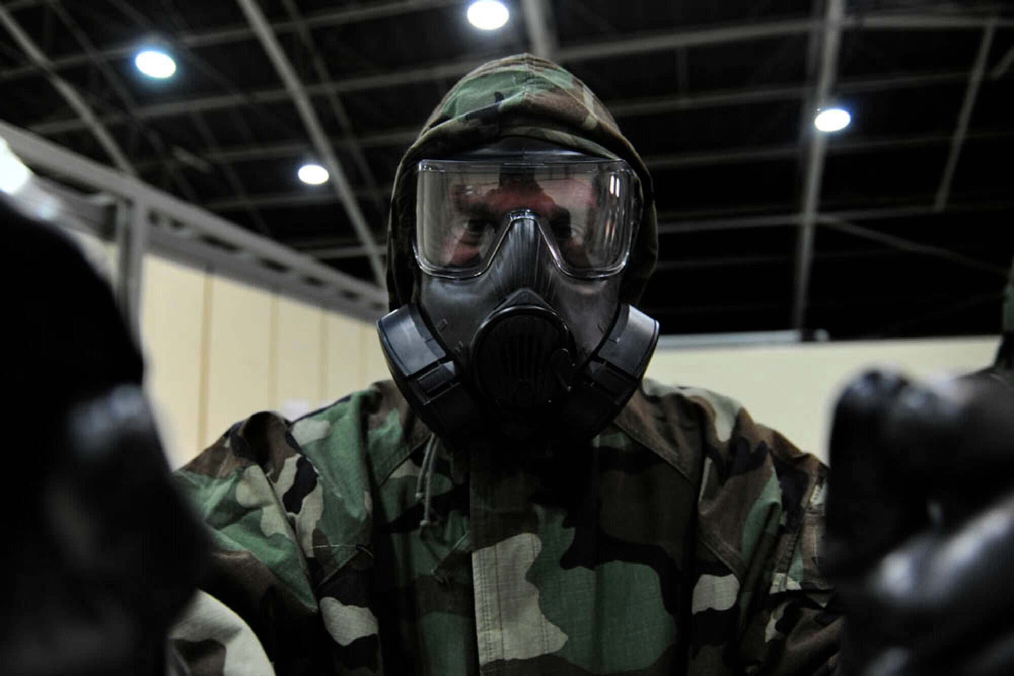 Tech. Sgt. James Fountain, 39th Air Base Wing safety office NCO in-charge of investigations, performs a buddy check while donning mission oriented protective posture gear April 29, 2015, at Incirlik Air Base, Turkey.  Airmen from across Incirlik reported for refresher training on chemical, biological, radiological and nuclear warfare procedures as part of a base wide exercise. (U.S. Air Force photo by Senior Airman Krystal Ardrey/Released)