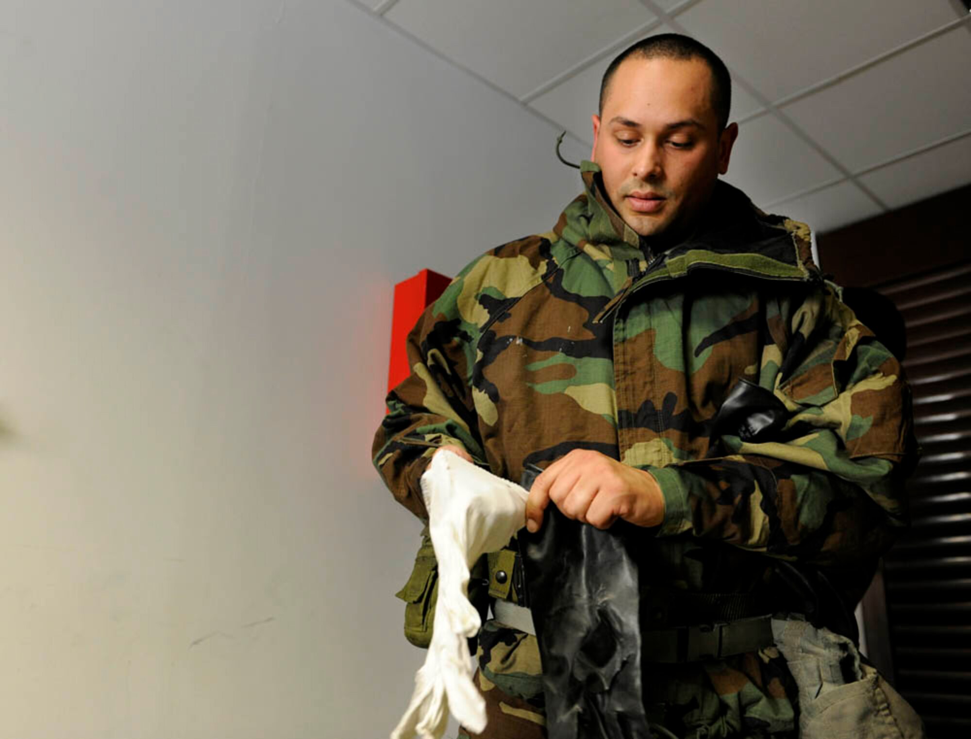 Staff Sgt. Anthony Acevedo, 39th Comptroller Squadron commander's support staff, dons mission oriented protective posture gear during a base wide exercise April 29, 2015, at Incirlik Air Base, Turkey. As part of the exercise, Acevedo and other Airmen were tested on chemical, biological, radiological and nuclear warfare knowledge. (U.S. Air Force photo by Senior Airman Krystal Ardrey/Released)