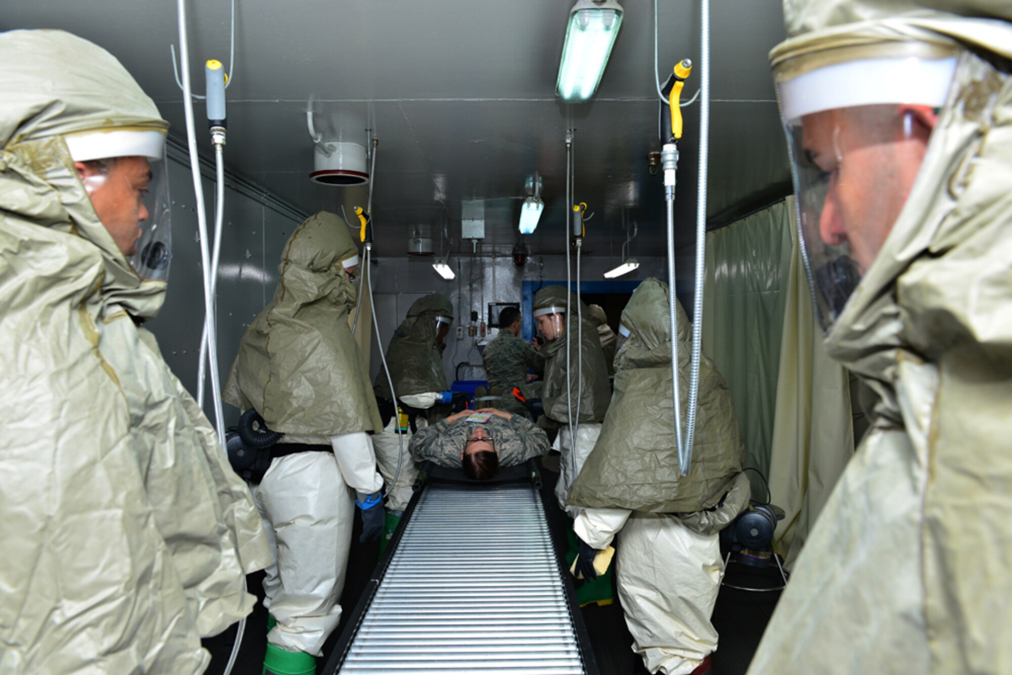 Staff Sgt. Candice Dane, 39th Medical Support Squadron medical logistics technician, processes through a decontamination line during a base-wide exercise April 29, 2015, at Incirlik Air Base, Turkey. The exercise is part of annual training designed to test the capabilities of the 39th Air Base Wing. (U.S. Air Force photo by Senior Airman Michael Battles/Released)