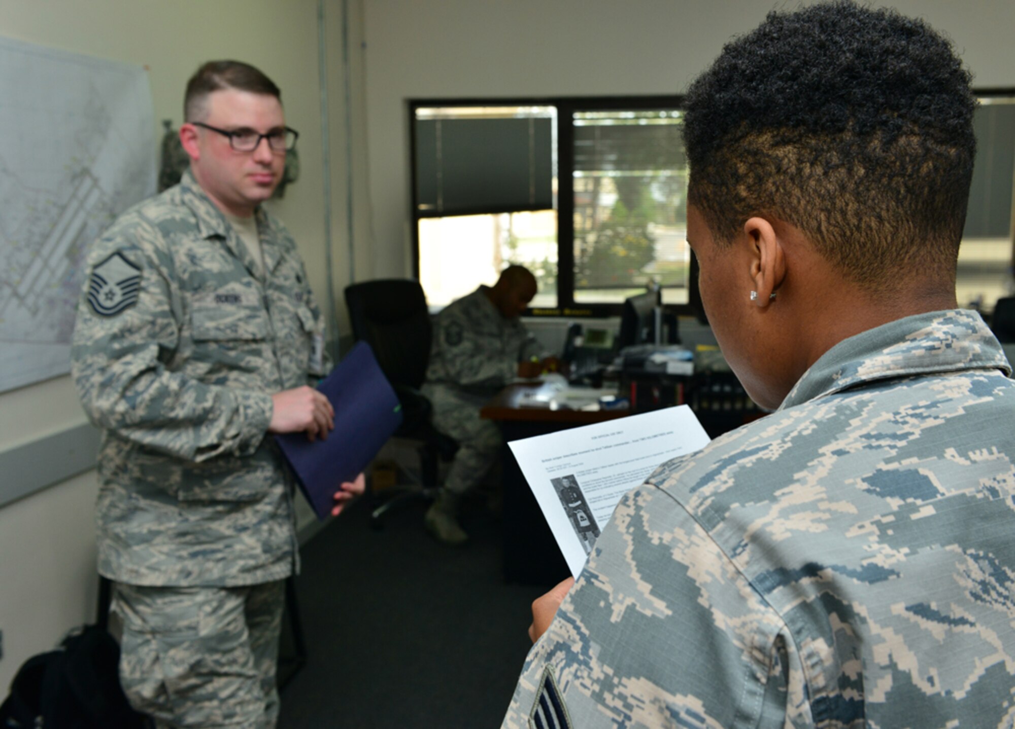 Master Sgt. Joshua Ockens, 39th Comptroller Squadron quality assurance manager, assesses Airman 1st Class Lisa Jones’, 39th Force Support Squadron fitness center technician, operational security knowledge during a base-wide exercise April 29, 2015, at Incirlik Air Base, Turkey. Throughout the exercise, Ockens tested members of Team Incirlik at random to verify their knowledge of OPSEC. (U.S. Air Force photo by Senior Airman Michael Battles/Released)