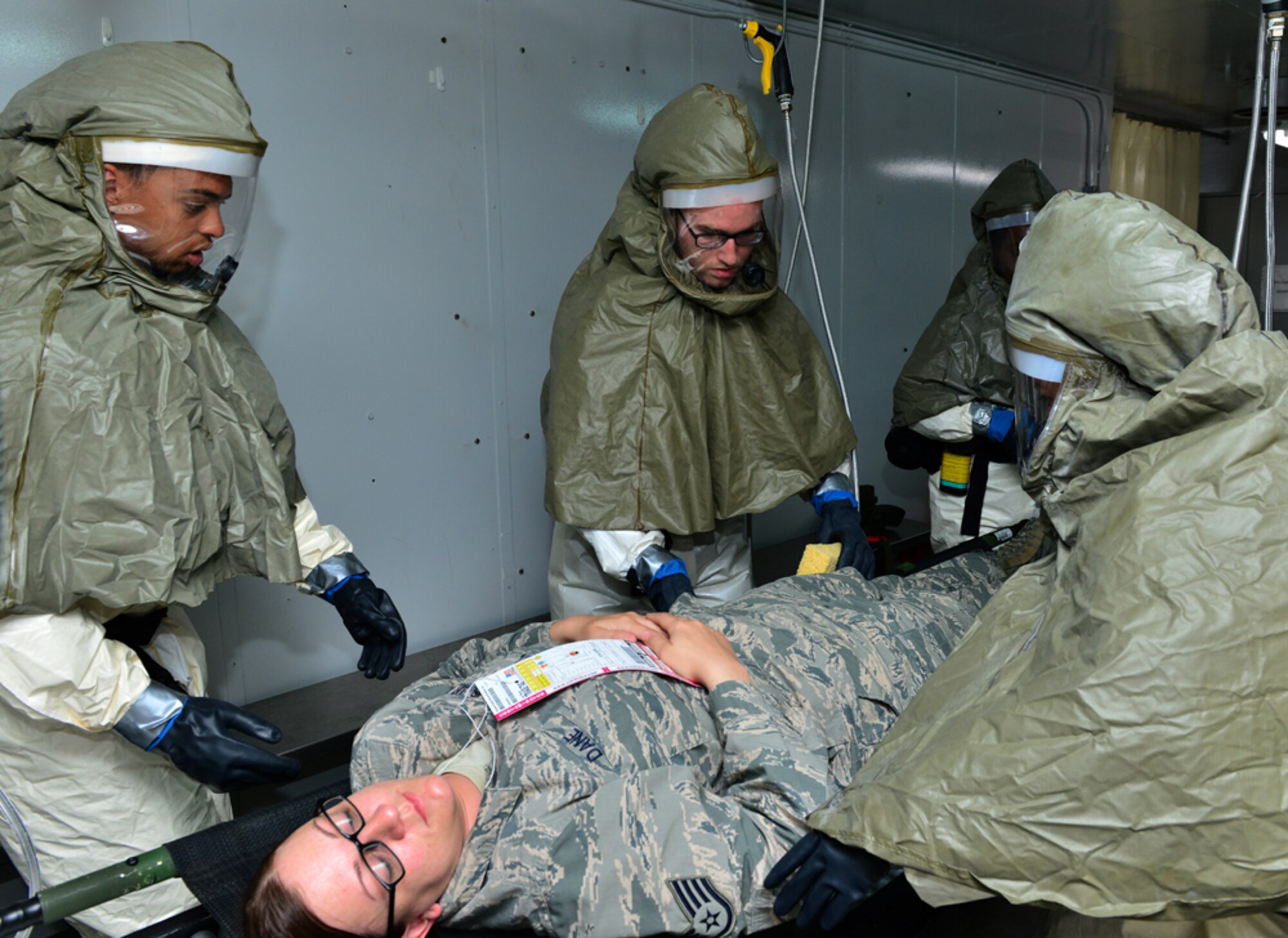 Staff Sgt. Candice Dane, 39th Medical Support Squadron medical logistics technician, processes through decontamination during a base-wide exercise April 29, 2015, at Incirlik Air Base, Turkey. The exercise is part of annual training designed to test the capabilities of the 39th Air Base Wing. (U.S. Air Force photo by Senior Airman Michael Battles/Released)