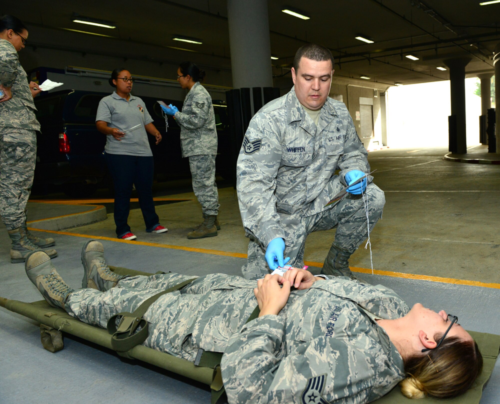 Staff Sgt. Adam Whiffen, 39th Medical Operations Squadron allergy and immunizations technician, assess the injuries of Staff Sgt. Candice Dane, 39th Medical Support Squadron medical logistics technician, during a base-wide exercise April 29, 2015, at Incirlik Air Base, Turkey. The five-day exercise was designed to test the capabilities of Team Incirlik in case of a real world emergency. (U.S. Air Force photo by Senior Airman Michael Battles/Released)