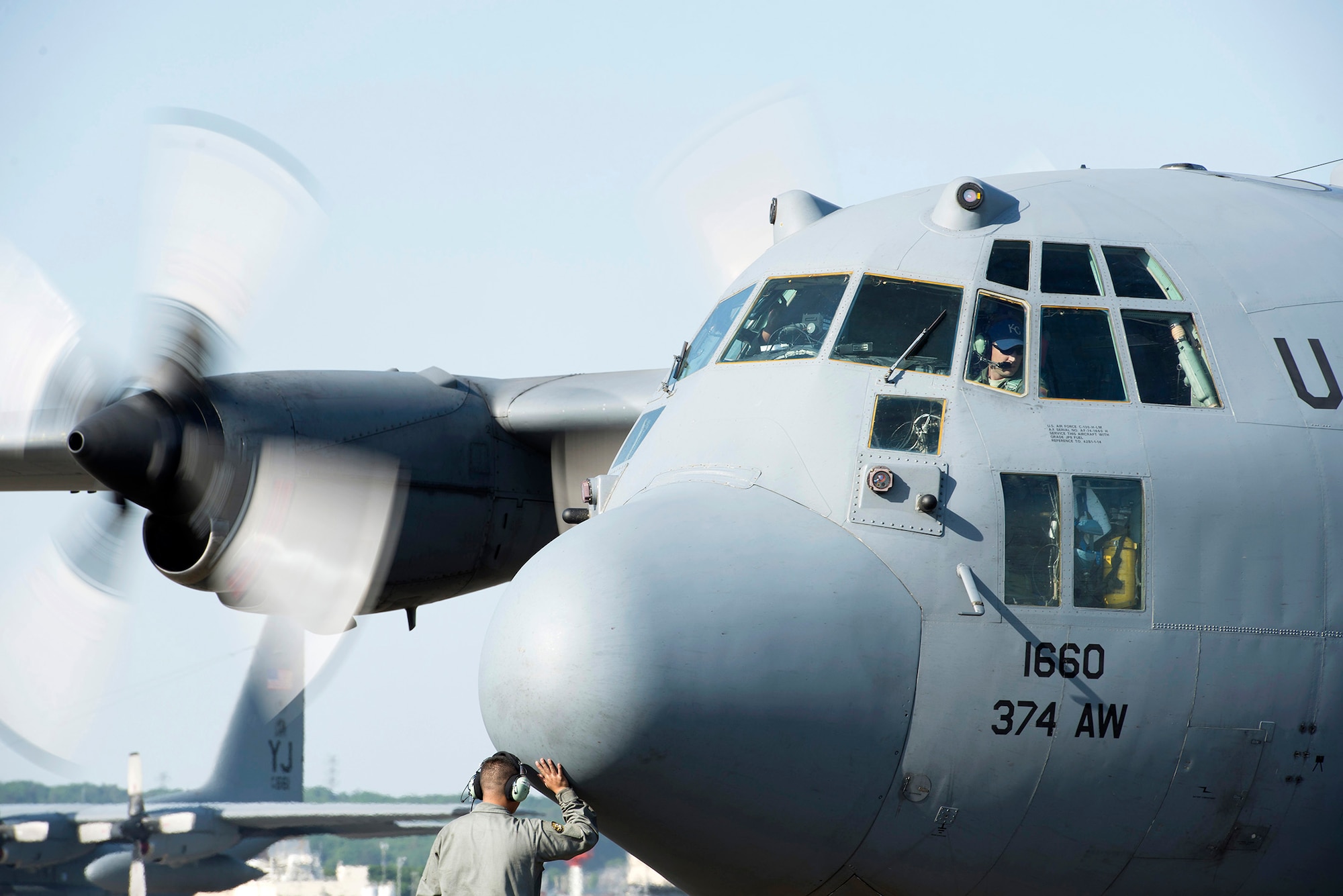 A crew chief with the 374th Aircraft Maintenance Squadron rubs the nose of a C-130 Hercules for good luck at Yokota Air Base, Japan, May 5, 2015. Members of Yokota left to provide humanitarian airlift and relief operations to support the U.S. Agency of International Development and the Government of Nepal in response to the 7.8 magnitude earthquake that devastated the country April 25, 2015. (U.S. Air Force photo by Staff Sgt. Cody H. Ramirez/Released)