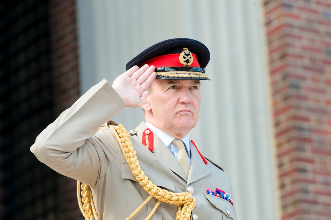 British Chief of Defense Staff Gen. Nick Houghton salutes during the playing of the U.S. and British national anthems at the National Defense University on Fort Lesley J. McNair in Washington, D.C., May 5, 2015.