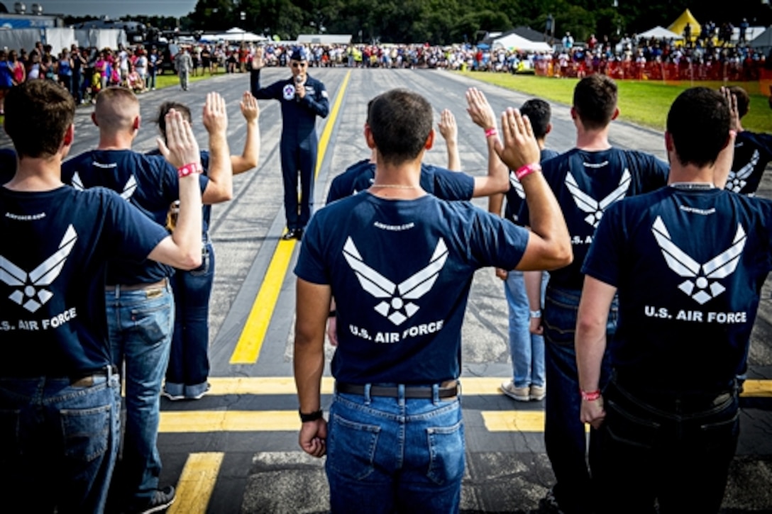 Air Force Maj. Tyler Ellison administers the oath of enlistment to Florida's newest airmen during an air show in Lakeland, Fla.. April, 25, 2015. 