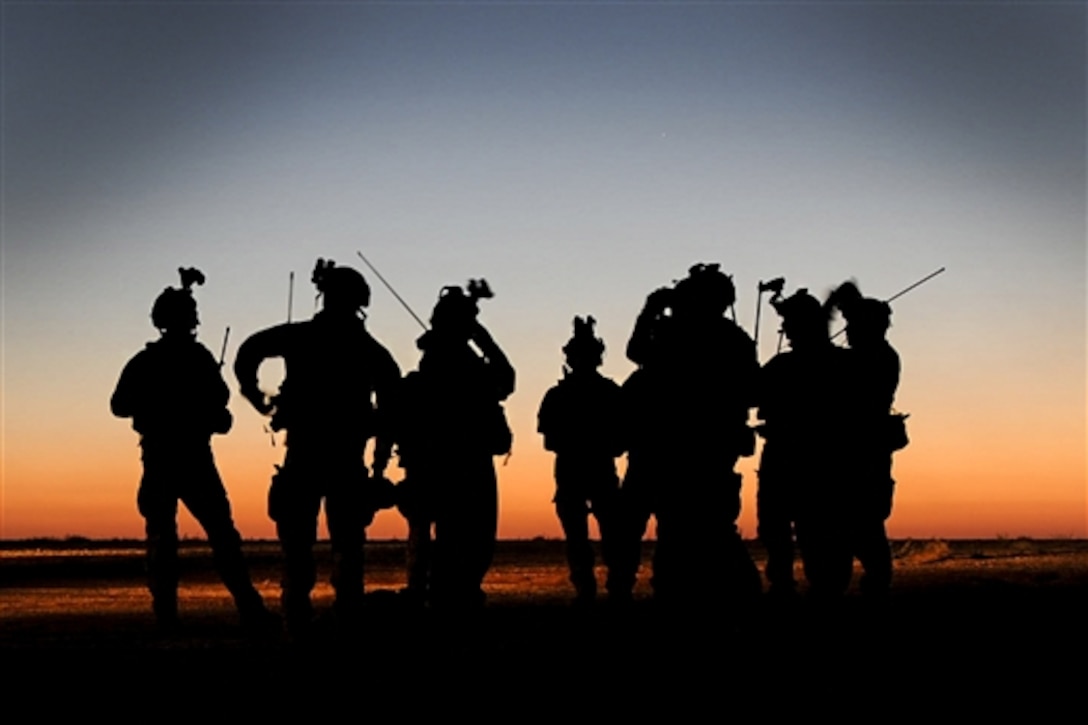 Soldiers and airmen gather on Melrose Air Force Range, N.M., to conduct a parachute jump during exercise Emerald Warrior, April 28, 2015. The soldiers are assigned to the 193rd Infantry Brigade and the airmen are assigned to the 26th Special Tactics Squadron. 