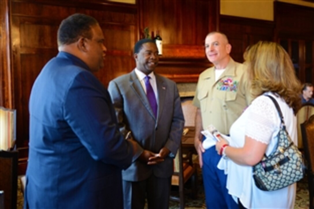 Alvin Brown, mayor of Jacksonville, Fla., left center, talks to Marine Corps Sgt. Maj. Bryan B. Battaglia, right center, the armed forces top senior enlisted leader, before the PGA Tour and The Player’s Championship Military Appreciation Day Ceremony at the TPC Sawgrass Clubhouse lawn in Ponte Vedra Beach, Fla., May 15, 2015. 