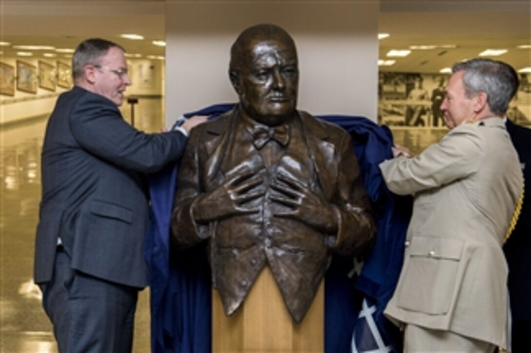 U.S. Deputy Defense Secretary Bob Work, left, and British Chief of Defense Gen. Nick Houghton unveil a bust of Sir Winston Churchill during a ceremony in which Houghton presented the bust to the Defense Department at the Pentagon, May 6, 2015. 
