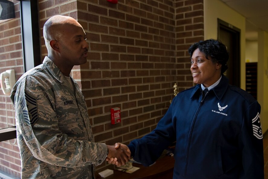 Chief Master Sgt. Cameron Kirksey, Air Force Reserve Command command chief master sergeant, coins Senior Master Sgt. Linda Mason-Wilson, 434th Operations Support Squadron first sergeant, during his visit to Grissom Air Reserve Base, Ind., May 2, 2015. Throughout the visit, Kirksey coined 16 additional members for their outstanding performance and contributions to their units. (U.S. Air Force photo/Tech. Sgt. Benjamin Mota)