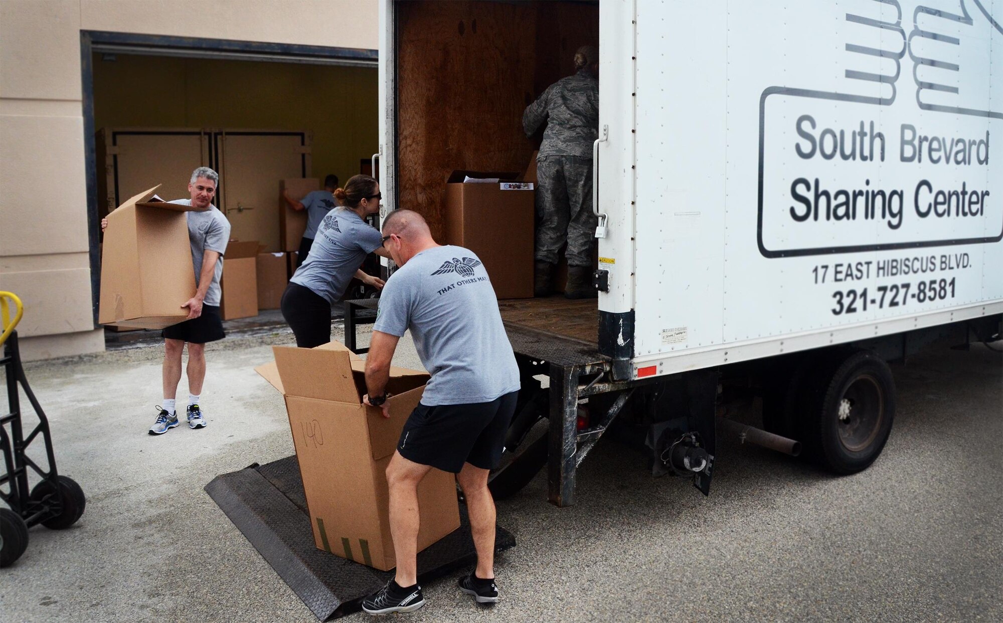 Reservists from the 920th Rescue Wing load roughly 1,200 pounds of canned and non-perishable food items onto a truck from the South Brevard Sharing Center (SBSC) after a month-long food drive. The event marks the second year in a row for the wing's support of the SBSC and its mission to fight local hunger. (U.S. Air Force photo/Master Sgt. Paul Flipse)