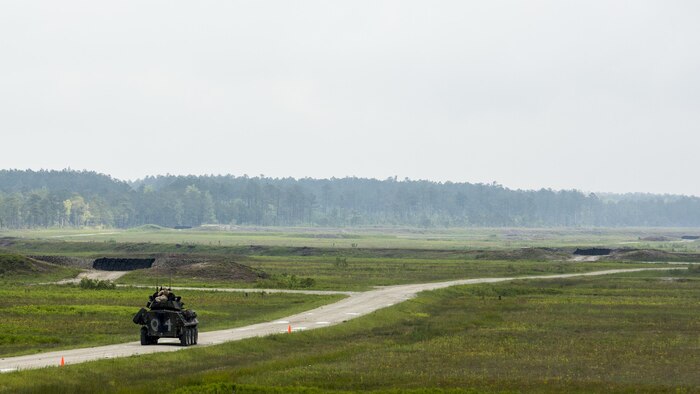 A light armored vehicle crew with Charlie Company, 2nd Light Armored Reconnaissance Battalion, 2nd Marine Division moves from one battle position to another during a pre-qualification on the LAV weapon systems aboard Marine Corps Base Camp Lejeune, North Carolina, May 1, 2015. During the exercise, the crew on the LAV moved from position to position to engage several targets and were evaluated on their accuracy, timeliness and effectiveness in identifying the target that presented the highest threat. 