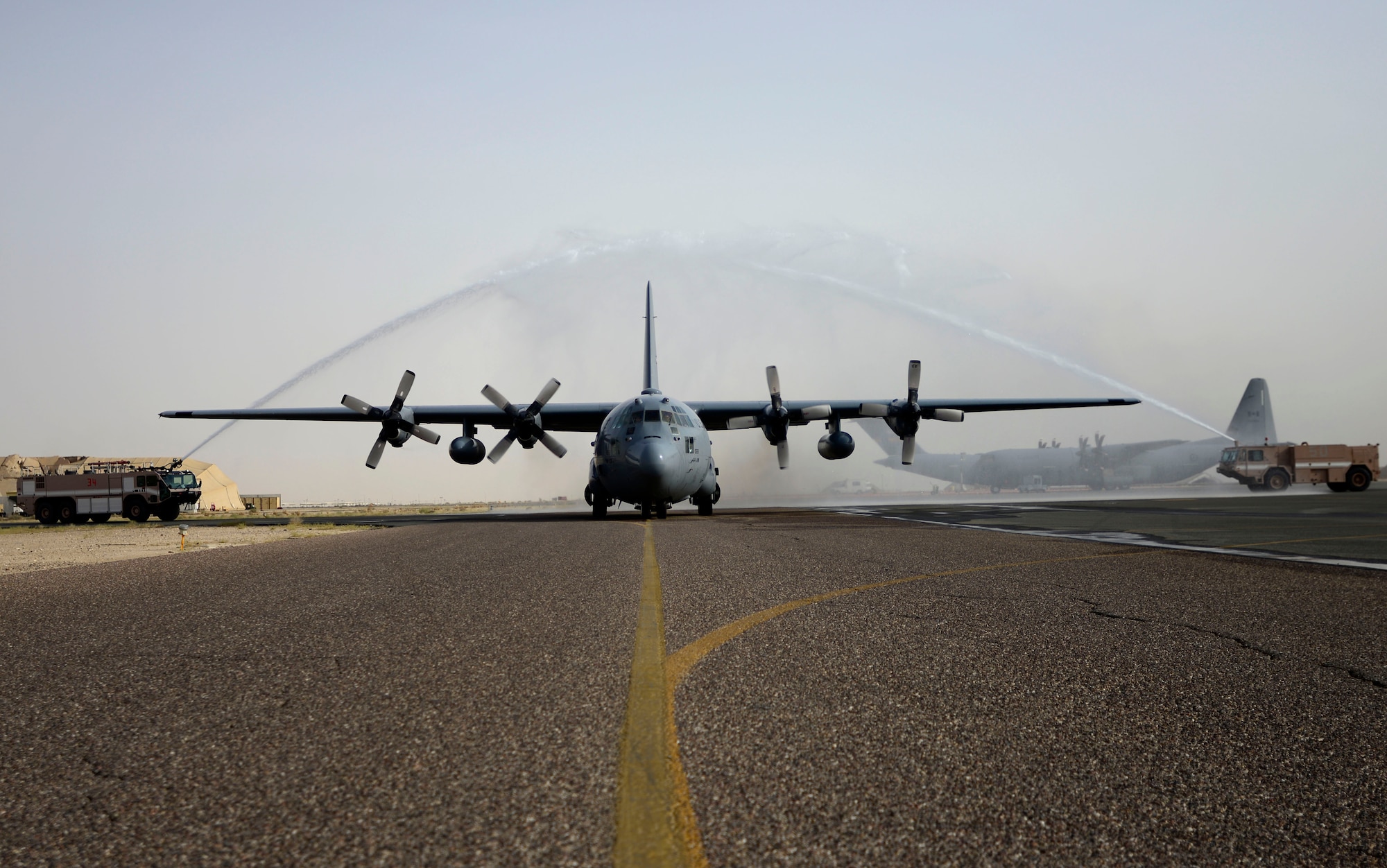 U.S. Air Force Col. Joe Santos, the 386th Expeditionary Operations Group commander, taxis a C-130 Hercules down the taxiway after his final flight at an undisclosed location in Southwest Asia May 6, 2015. The final flight signified the last flight Santos took as the commander. (U.S. Air Force photo by Senior Airman Racheal E. Watson)