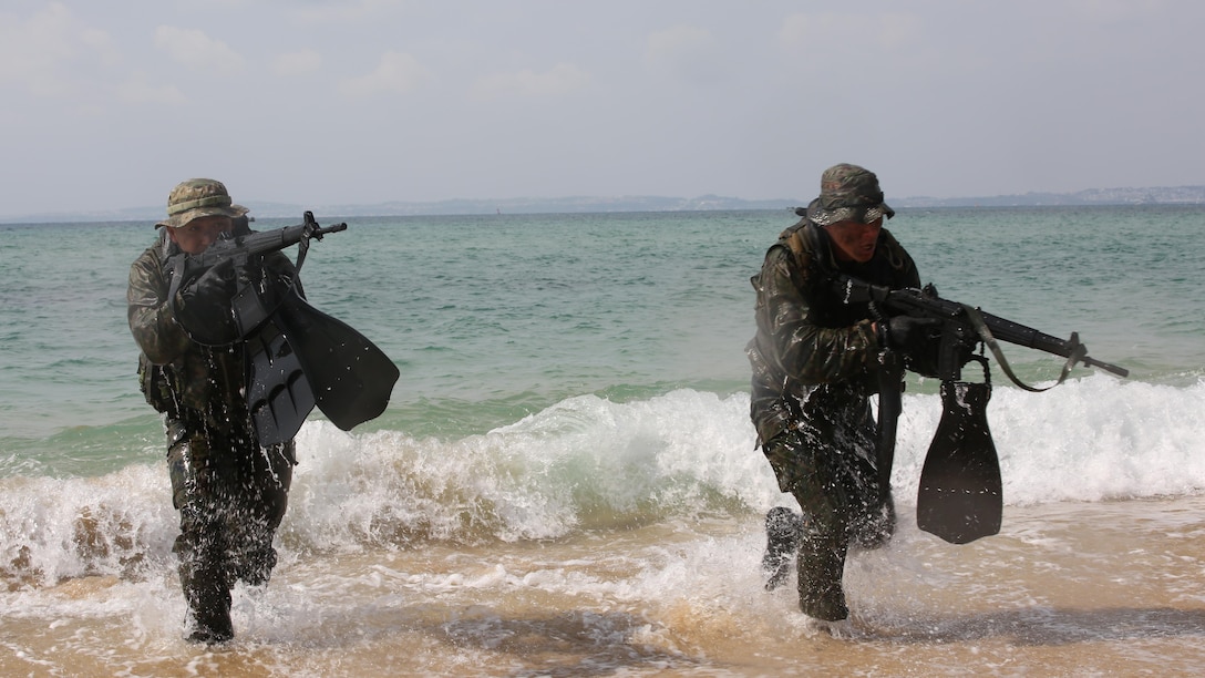 Japanese Ground Self-Defense Force scout swimmers emerge out of the ocean and run to the beach during the Japanese Observer Exchange Program April 27, 2015 at Kin Blue. JOEP is a III Marine Expeditionary Force, 31st Marine Expeditionary Unit and JGSDF coordinated program designed to increase regional security, maintain unit readiness and enhance overall cooperation. This is the fourth iteration of JOEP for the 31st MEU after the initial partnership in September 2012. (U.S. Marine Corps photo by Cpl. Ryan C. Mains/Released)