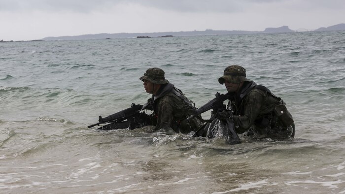 Japanese Ground Self-Defense Force scout swimmers emerge out of the water and sight in on their rifles during the Japanese Observer Exchange Program April 28, 2015 at Kin Blue. JOEP is a III Marine Expeditionary Force, 31st Marine Expeditionary Unit and JGSDF coordinated program designed to increase regional security, maintain unit readiness and enhance overall cooperation. This is the fourth iteration of JOEP for the 31st MEU after the initial partnership in September 2012. (U.S. Marine Corps photo by Cpl. Ryan C. Mains/Released)