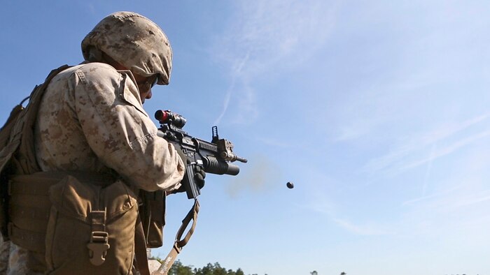 Lance Cpl. Xavier Castro, a rifleman with 1st Battalion, 8th Marine Regiment, fires his M203 rifle-mounted grenade launcher during a M203 qualification aboard Marine Corps Base Camp Lejeune, North Carolina, April 5, 2015. The M203 grenade launcher fires various types of 40 mm ammunition, ranging from high explosive to ground marking rounds.
