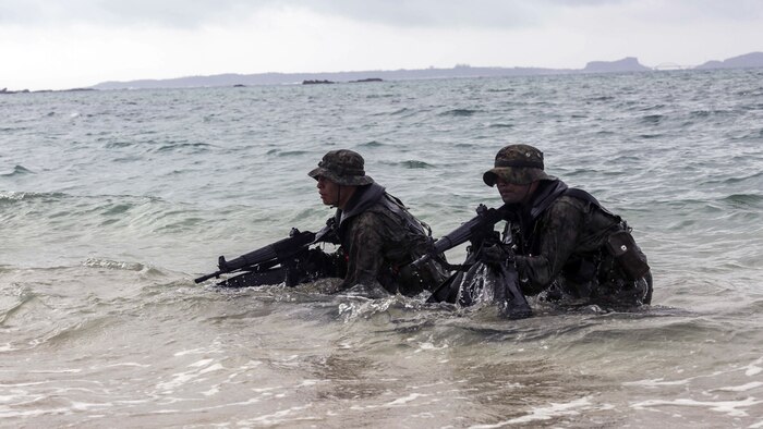 In this photo file, Japanese Ground Self-Defense Force scout swimmers emerge out of the water and sight in on their rifles during the Japanese Observer Exchange Program April 28, 2015 at Kin Blue. JOEP is a III Marine Expeditionary Force, 31st Marine Expeditionary Unit and JGSDF coordinated program designed to increase regional security, maintain unit readiness and enhance overall cooperation. This is the fourth iteration of JOEP for the 31st MEU after the initial partnership in September 2012. 