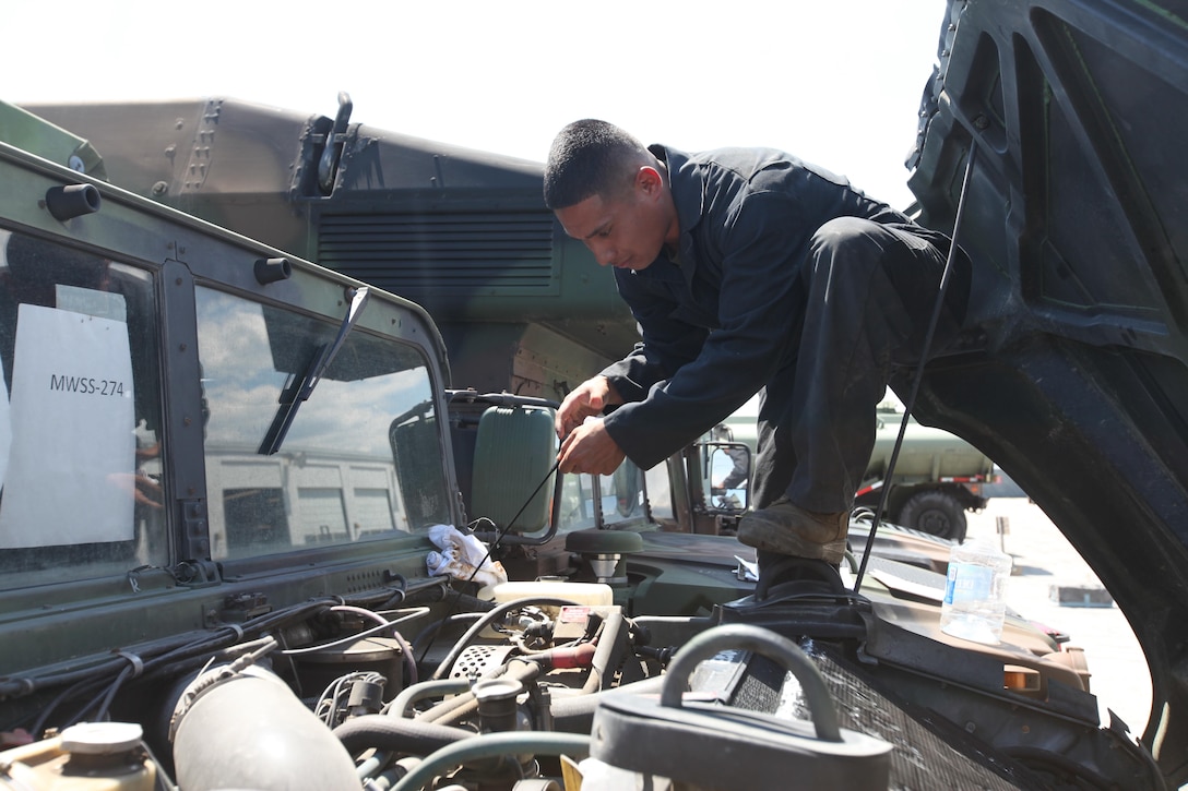 Corporal Alfonso Rodriguez checks the oil on a tactical vehicle at Marine Corps Air Station Cherry Point, North Carolina, May 4, 2015. Maintenance Marines with Marine Wing Support Squadron 271 conduct preventative maintenance daily to ensure the tactical vehicles are ready at a moment’s notice. Rodriguez is a mechanic with MWSS-271. 