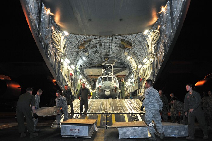 In this photo, Airmen from the 36th Contingency Response Group and U.S. Marines to prepare to unload a U.S. Marine UH-1Y Huey helicopter from a U.S. Air Force C-17 Globemaster III on May 2015 at Tribhuvan International Airport, Nepal. The 36th CRG is a rapid-deployment unit designed to establish and maintain airfield operations in a forward operating location and joined U.S. Department of State and U.S. Agency for International Development led humanitarian assistance and disaster relief operations in support of the government and armed forces of Nepal. 
