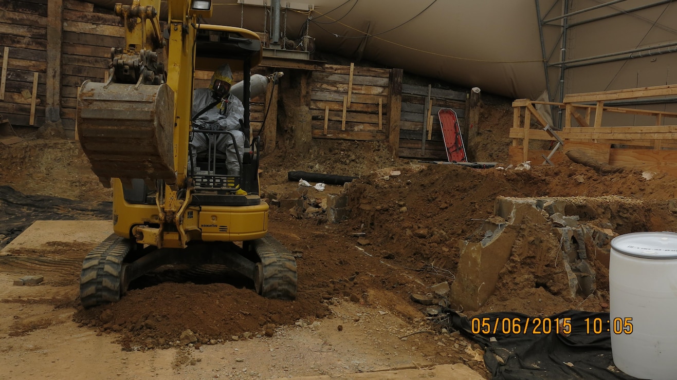 Crews continue scrapping and digging the soils and concrete in the former back porch area at 4825 Glenbrook Road.  
