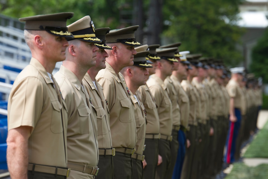 Officers stand at attention during a “play-off” for outgoing staff non-commissioned and commissioned officers at Marine Barracks Washington, D.C., May 7, 2015. The "play-off" is a tradition at the barracks that begins with three songs performed by the U.S. Marine Drum and Bugle Corps. Staff NCOs and officers line the parade deck and salute as the outgoing staff NCOs and officers walk past.


(U.S. Marine Corps photo by Cpl. Skye Davis/Released)