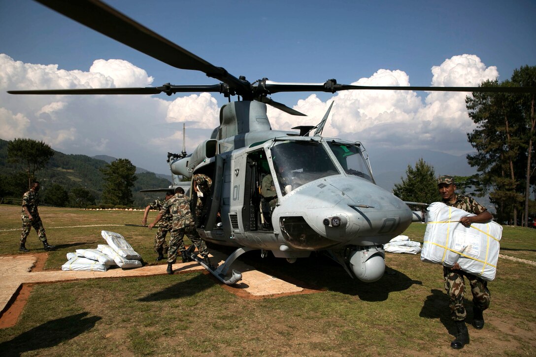 Nepalese military service members unload supplies from a UH-1Y Huey in Charikot, Nepal, May 5, Nepal, May 5. Marines with Marine Light Attack Helicopter Squadron 469 and Marine Medium Tilt Rotor Squadron 262 carried supplies in a UH-1Y Huey and MV-22 Ospreys to Charikot, Nepal. The supplies will provide Nepalese people with shelter after a 7.8 magnitude earthquake struck central Nepal, April 25, causing fatalities, injuries and significant damage. The government of Nepal declared a state of emergency and requested international assistance. The U.S. military, at the direction of the U.S. Agency for International Development, will continue to support Nepal as needed. HMLA-469 and VMM-262 are attached to Marine Aircraft Group 36, 1st Marine Aircraft Wing, III Marine Expeditionary Force.