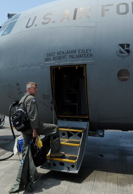 U.S. Air Force Brig. Gen. Michael A. Minihan, commander of Joint Task Force 505’s Joint Air Component Coordination Element, pauses for a moment to take one last look at Kadena Air Base before stepping onto the C-130J Hercules, May 7, 2015. The element departed for Thailand in support of the humanitarian mission in Nepal-- working closely with the U.S. Department of State, U.S. Agency for International Development, and other U.S. agencies to ensure continued, timely and swift responses to requests by the Government of Nepal. (U.S. Air Force photo by Airman 1st Class Zackary A. Henry)