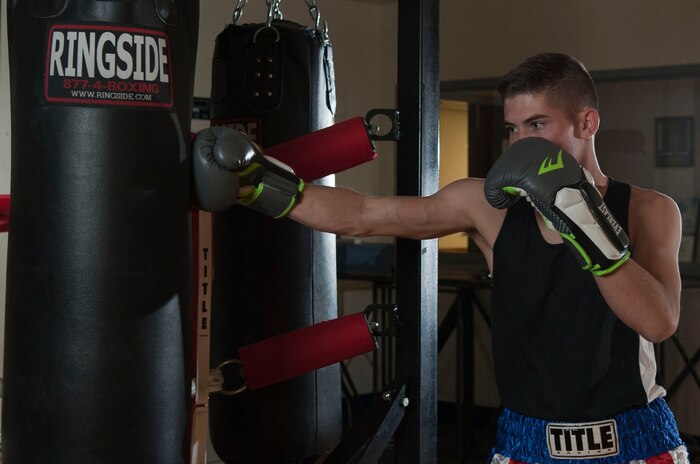 Airman 1st Class Justin Krantz, 99th Civil Engineer Squadron electrical systems apprentice, strikes a punching bag at the Community Center on Nellis Air Force Base, Nev., May 5, 2015. Krantz hopes to one day go to the Olympics through the U.S. Air Force boxing team. (U.S. Air Force photo by Airman 1st Class Mikaley Towle)