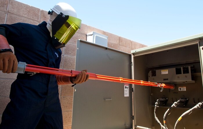 Airman 1st Class Justin Krantz, 99th Civil Engineer Squadron electrical systems apprentice, performs a switching operation to isolate the secondary power from a facility at Nellis Air Force Base, Nev., April 28, 2015. The 99th CES provides many forms of maintenance support for facilities and infrastructure, fire protection and crash rescue, disaster preparedness, environmental compliance, explosive ordnance demolition and oversight for privatized military family housing. (U.S. Air Force photo by Airman 1st Class Mikaley Towle)