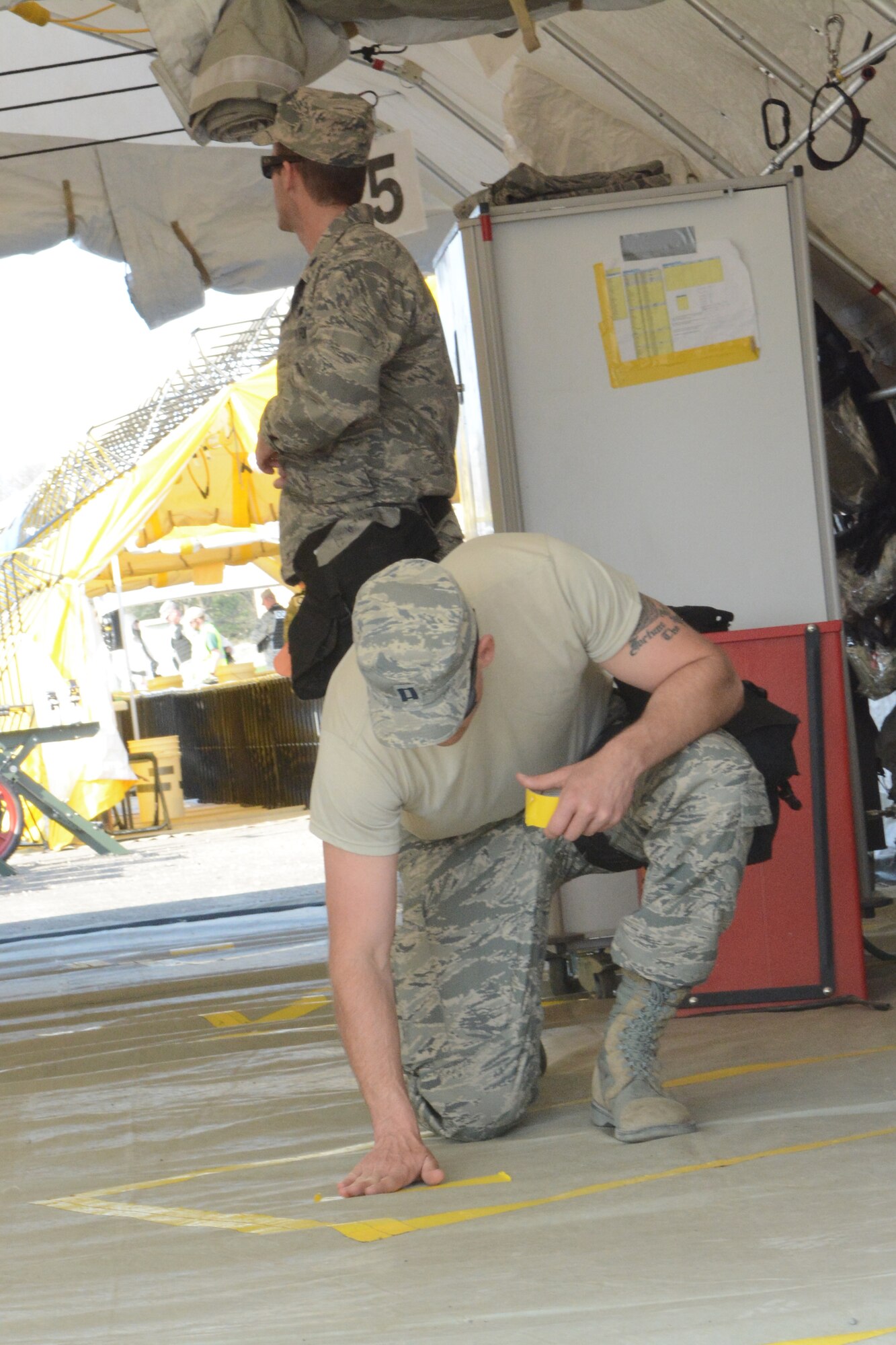 Yellow tape is used to mark each patient area within the medical tent during a two-day Chemical, Biological, Radiological, Nuclear and Explosives Enhanced Response Force Package exercise at Volk Field Air National Guard Base, Wis., May 1-2. The exercise allowed service members to prepare for the first ever CERFP one-day inspection, scheduled to be held in June 2015. (U.S. Air National Guard photo by Senior Airman Andrea F. Rhode)