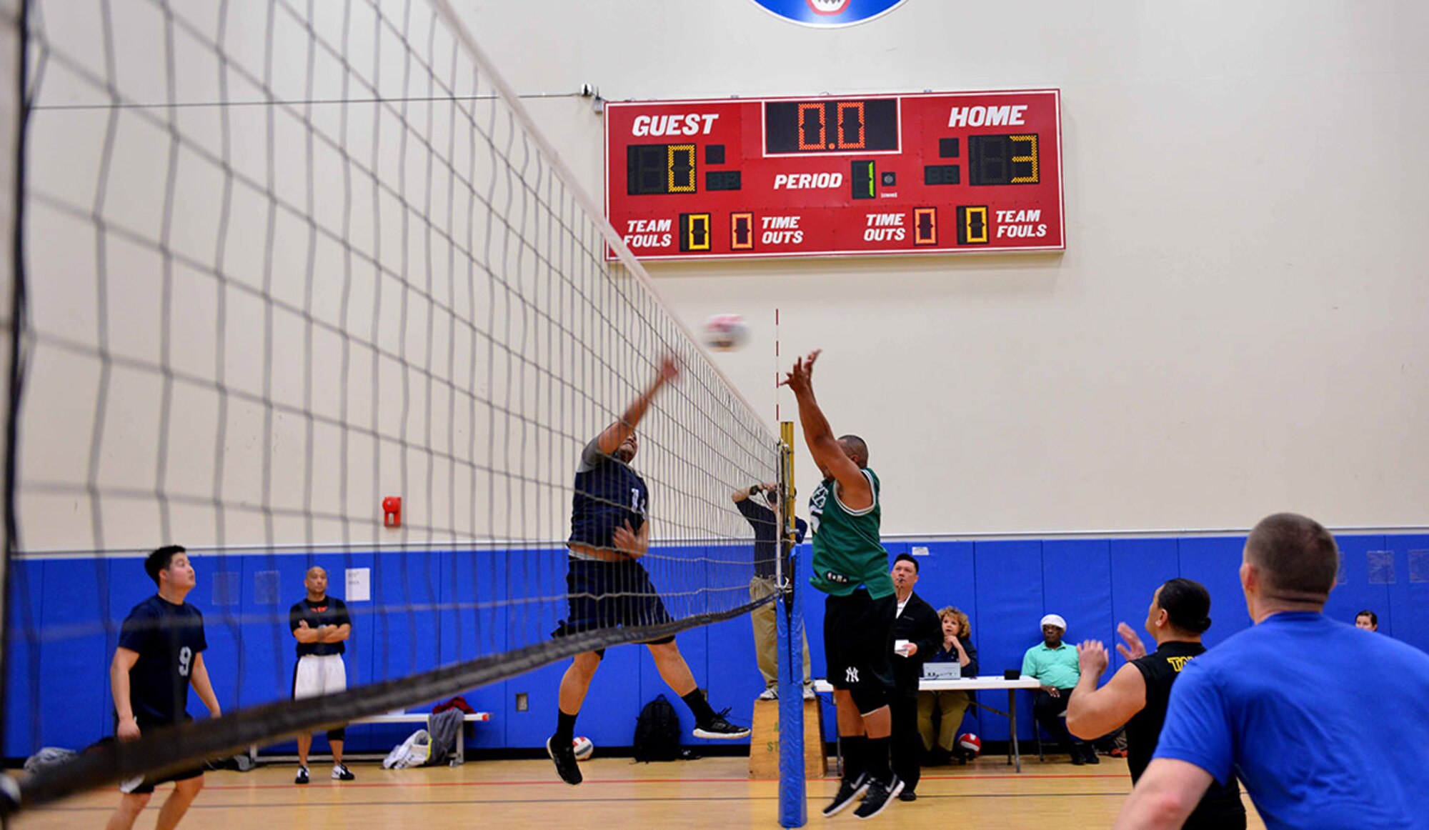 Army 1st Lt. Agaalofa Tauane, a native of American Samoa and executive officer for H Company, 3rd Battalion (Airborne), 509th Infantry Division, spikes the volleyball over the block of a player from the opposing team at the intramural volleyball championship game, April 30 at Buckner Physical Fitness Center. Tauane's team secured victory, maintained their undefeated record, and grabbed the trophy. (U.S. Air Force photo/Airman 1st Class Kyle Johnson)