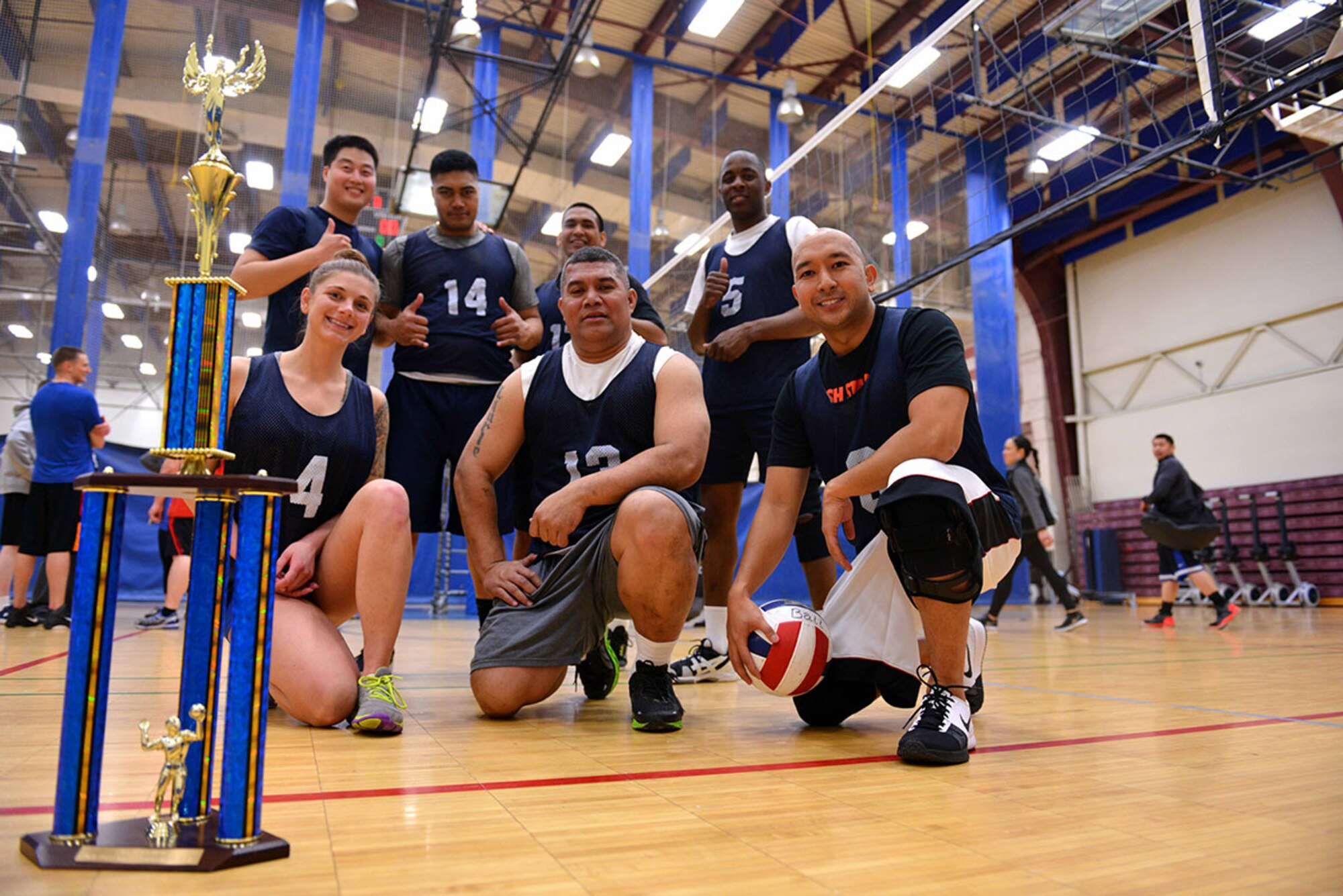 The champions of the intramural volleyball championship pose next to their trophy at Buckner Physical Fitness Center on Joint Base Elmendorf-Richardson, April 30th. The team, composed of Army and Air Force players, played 16 games with 16 victories. (U.S. Air Force Photo/Airman 1st Class Kyle Johnson)