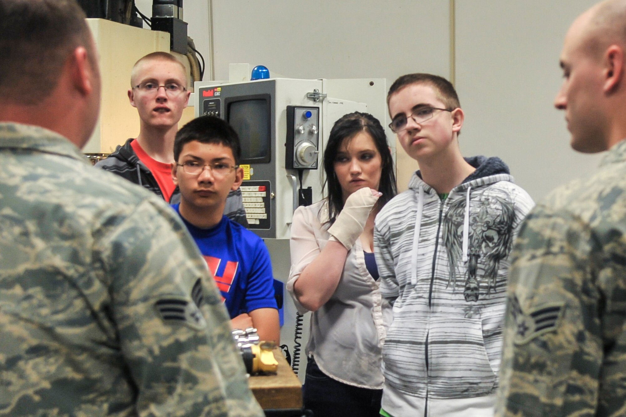 Senior Airman Kevin Fredenburg, 92nd Maintenance Squadron metals technician, shows students from Medical Lake High School Junior ROTC a part the shop made from scratch May 4, 2015, at Fairchild Air Force Base, Wash. The students were on a tour of the base that included stops at the aerospace and operational physiology training unit, the 92nd Operations Support Squadron weather flight and the 92nd Maintenance Squadron metals technology flight. (U.S. Air Force photo/Airman 1st Class Taylor Bourgeous)