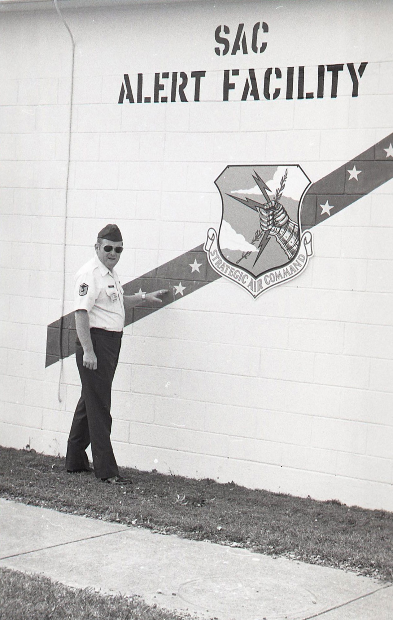 Then-Senior Master Sgt. Morris Pickel stands by the Strategic Air Command seal in Okinawa, Japan, in 1981. (Courtesy Photo)