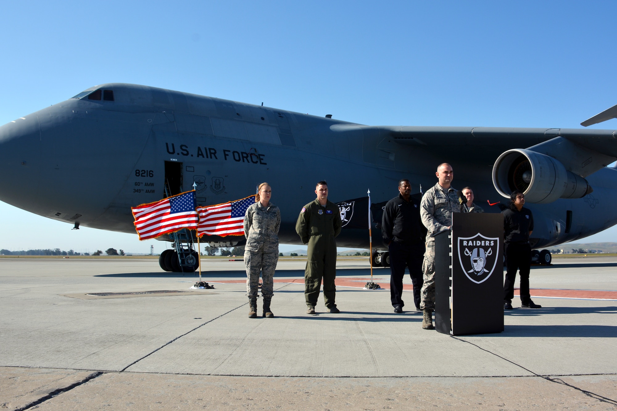 Senior Airman John Dunkel, 860th Aircraft Maintenance Squadron crew chief, prepares to announce the 29th pick in the fourth round of the NFL Draft for the Oakland Raiders May 2, 2015, at Travis Air Force Base, California. Dunkel was born and raised in the local area and his family has been season ticket holders since was he 8 years old. (U.S. Air Force photo by Senior Airman Charles Rivezzo)