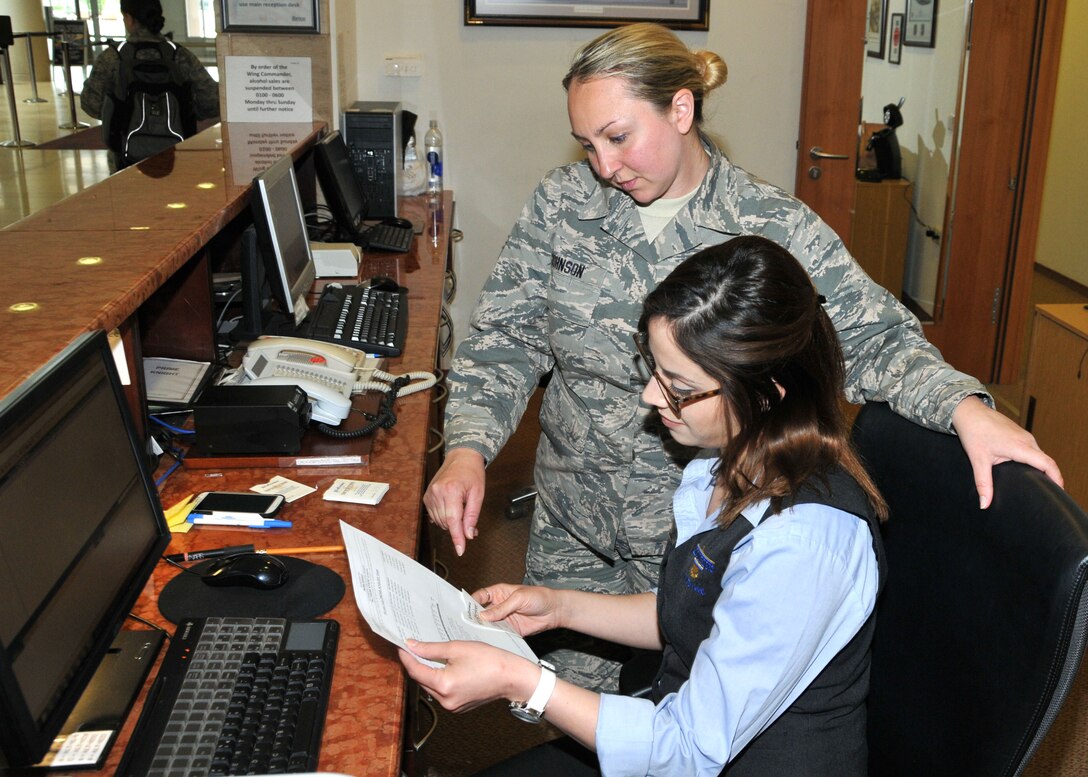 Staff Sgt. Adrianne Johnson, 104th Services Flight, Barnes Air National Guard Base, Westfield, Mass., receives training on front desk procedures from Ayesgui Gignac, Guest Services Representative, May 7, 2015, on the front desk computer system, Air Force Inn, Kaiserslautern Military Community Center, Ramstein Air Base, Germany. Johnson trained at the KMCC Air Force Inn May 5-7 in the areas of housekeeping, inspecting rooms, accounting, reservations, and supply, allowing her to sign off on requirements for her services position. (U.S. Air National Guard photo by Tech. Sgt. Melanie J. Casineau/ Released)