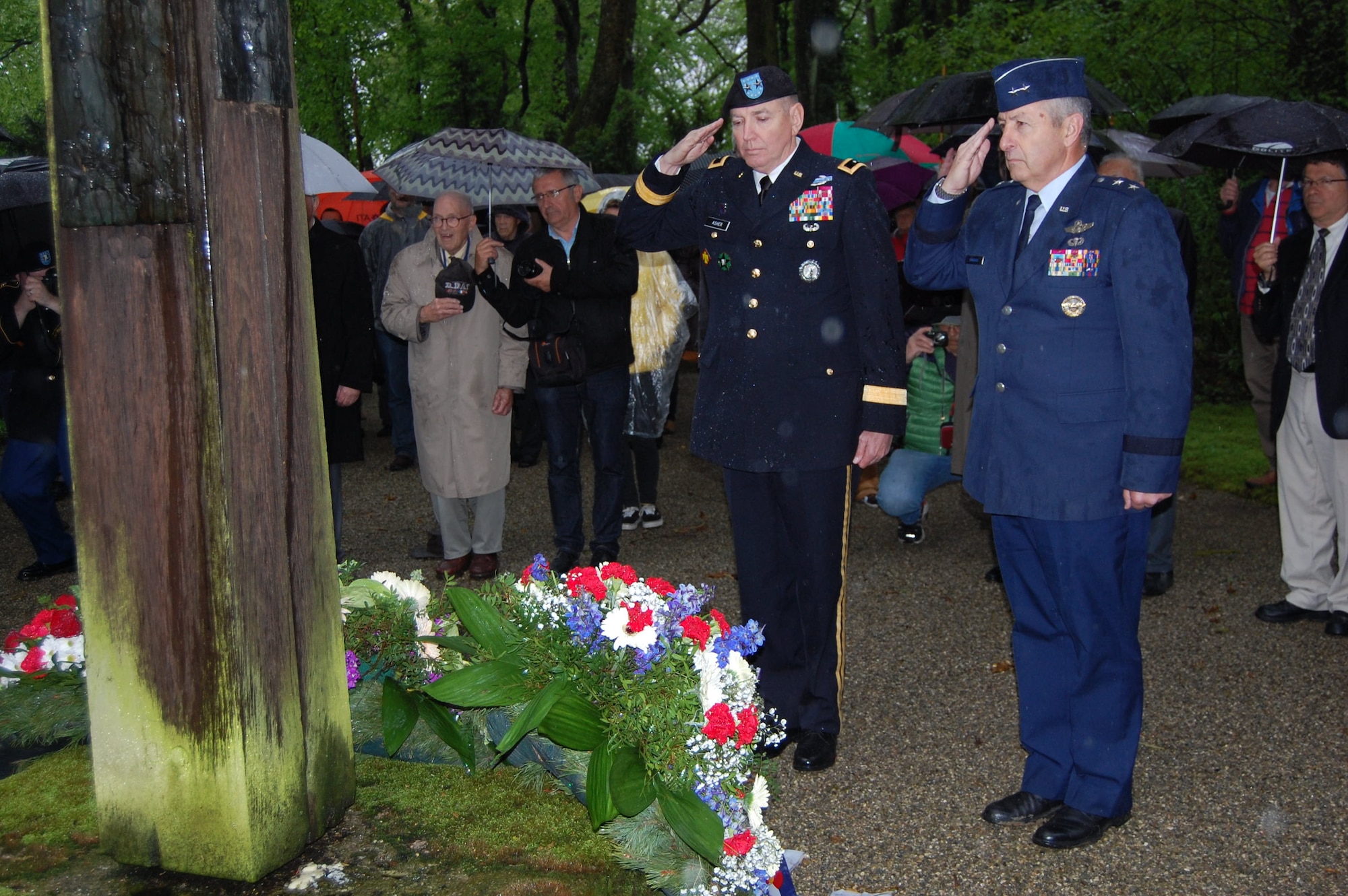 Maj. Gen. Robbie Asher, the Adjutant General of Oklahoma, and Maj. Gen. H. Michael Edwards, the Adjutant General of Colorado, salute in reverence after laying a wreath in honor of the several thousand prisoners who were buried in Leitenberg Cemetery after passing away in Dachau Concentration Camp. Members of the Colorado and Oklahoma National Guard participated in various ceremonies May 1-3, 2015, commemorating the 70th anniversary of the liberation of the concentration camp, Dachau. The 157th Infantry Regiment, one of the units that liberated the camp on April 29, 1945, initially mustered from the state of Colorado. The regiment was a subordinate unit to the 45th Infantry Division, initially formed in Oklahoma. (Air National Guard photo by Capt. Kinder Blacke)